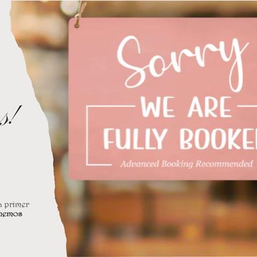 Sign reads 'Sorry, we are fully booked' with a blurred background.