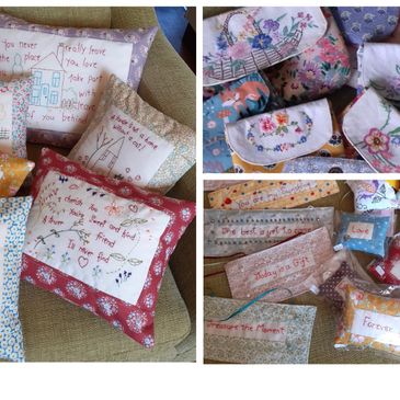 Handmade embroidered pillows and small fabric gift bags with floral designs.