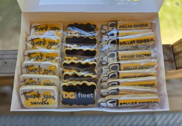 Box of custom decorated cookies with thank you and Dollar General themes.
