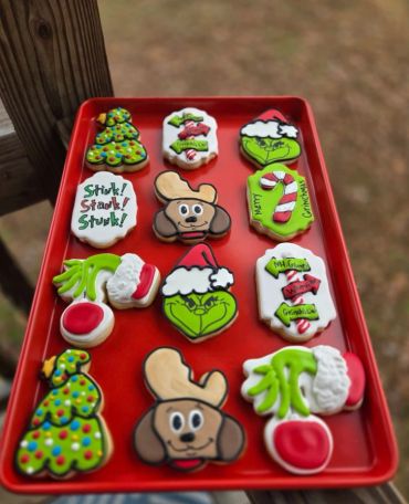 Tray of colorful Christmas-themed decorated cookies.