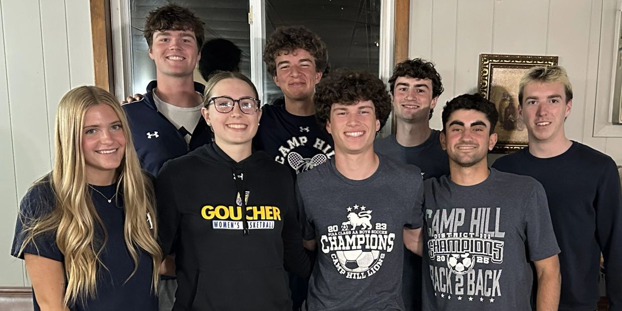 A group of young adults smiling indoors.