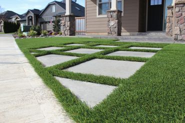 Pavers look great cut into artificial turf. 