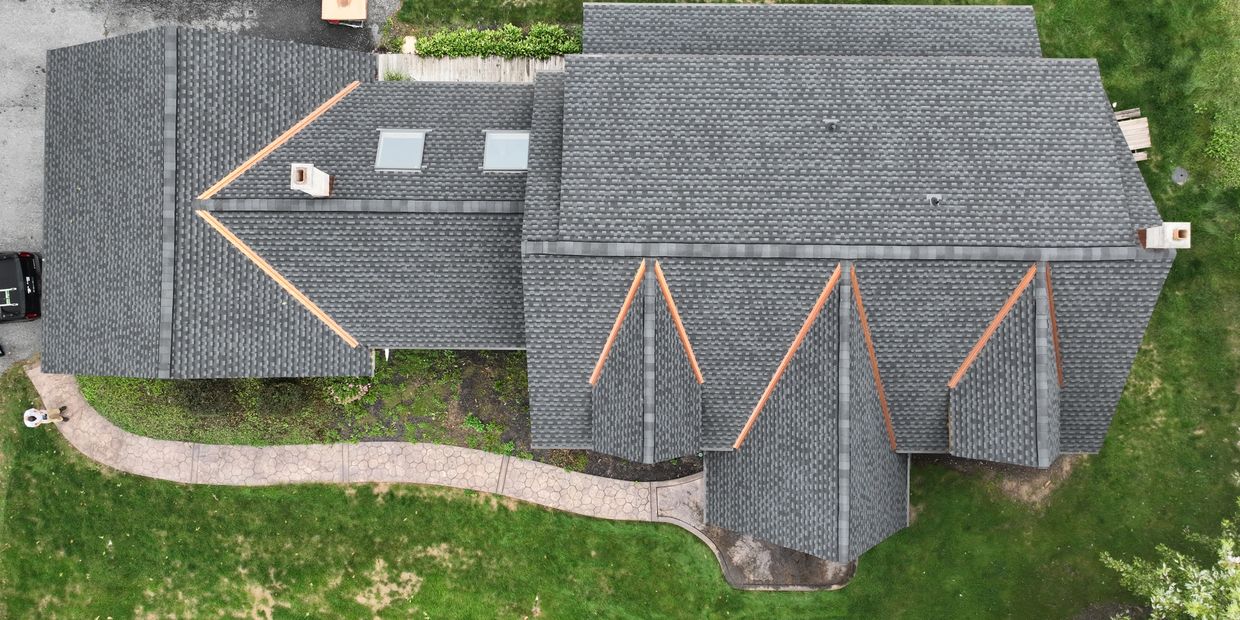 GAF UHDZ shingles with open copper valleys and new Velux skylights on this beautiful home.