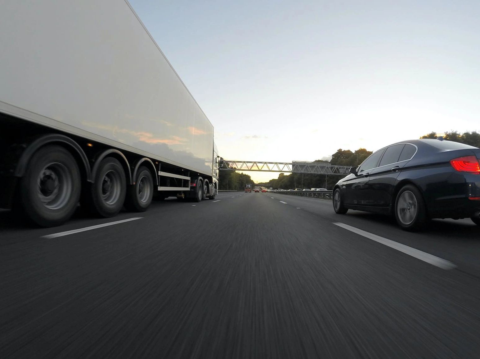 Tractor-trailer and car on highway.