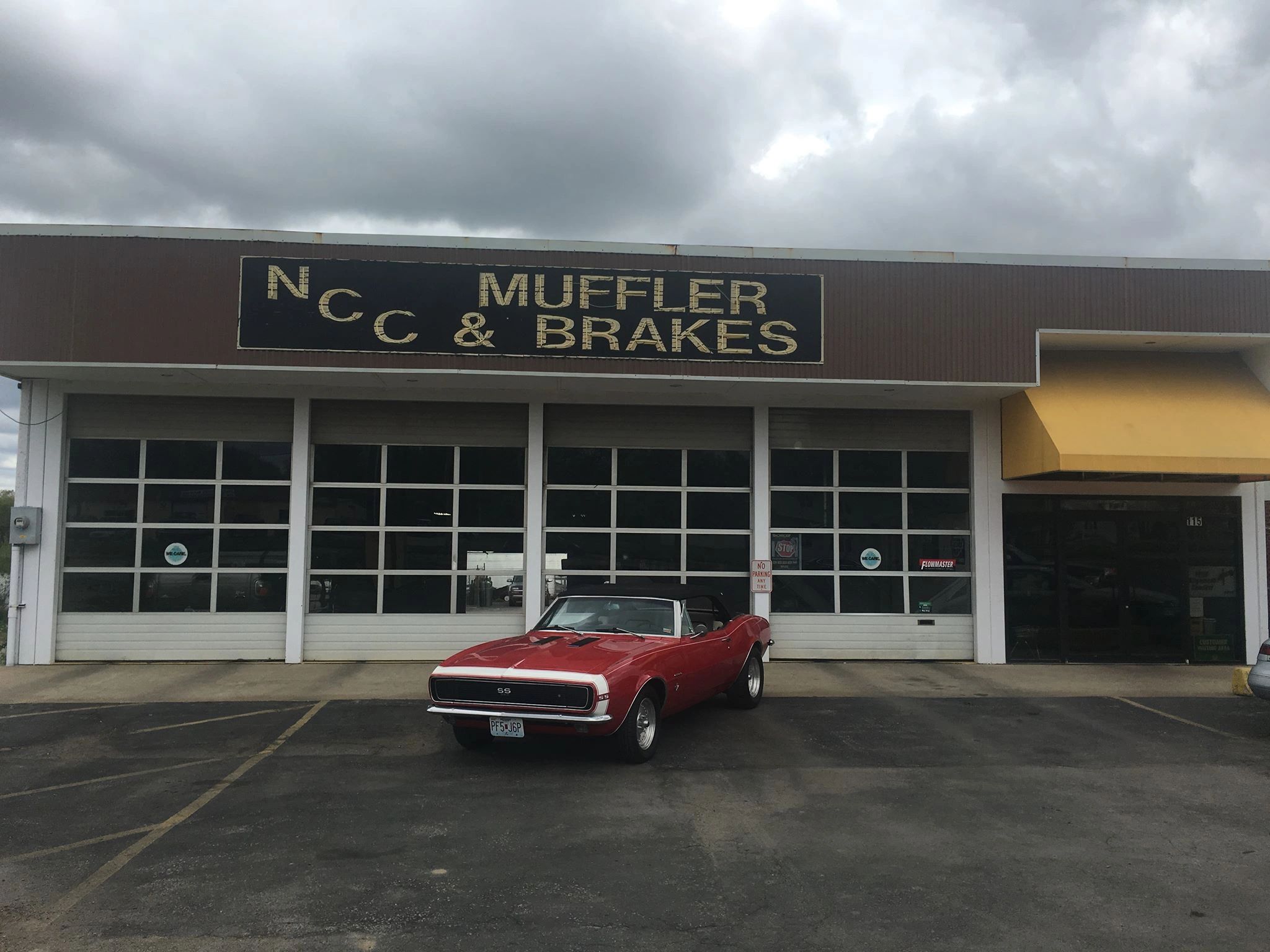 NCC Muffler & Brakes — Camaro in front of the shop