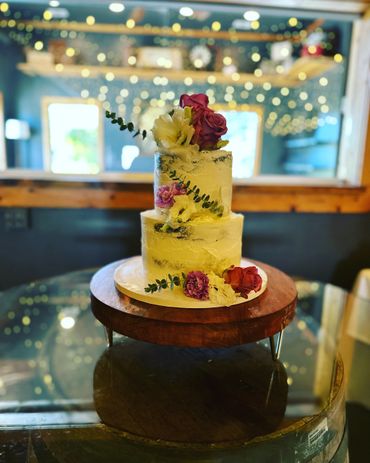 Semi naked rustic wedding cake. Lemon blueberry and strawberry cakes