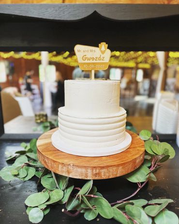Simple yet elegant wedding cake. Ridging on the bottom tier and custom cake topper. 