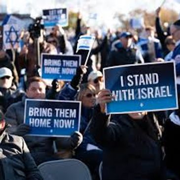 Group of people holding signs that read STAND WITH ISRAEL