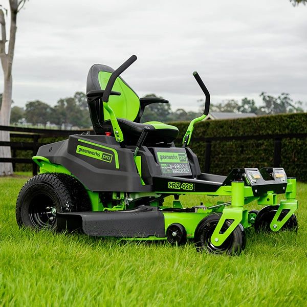 Greenworks Pro ride-on lawn mower on a grassy field.