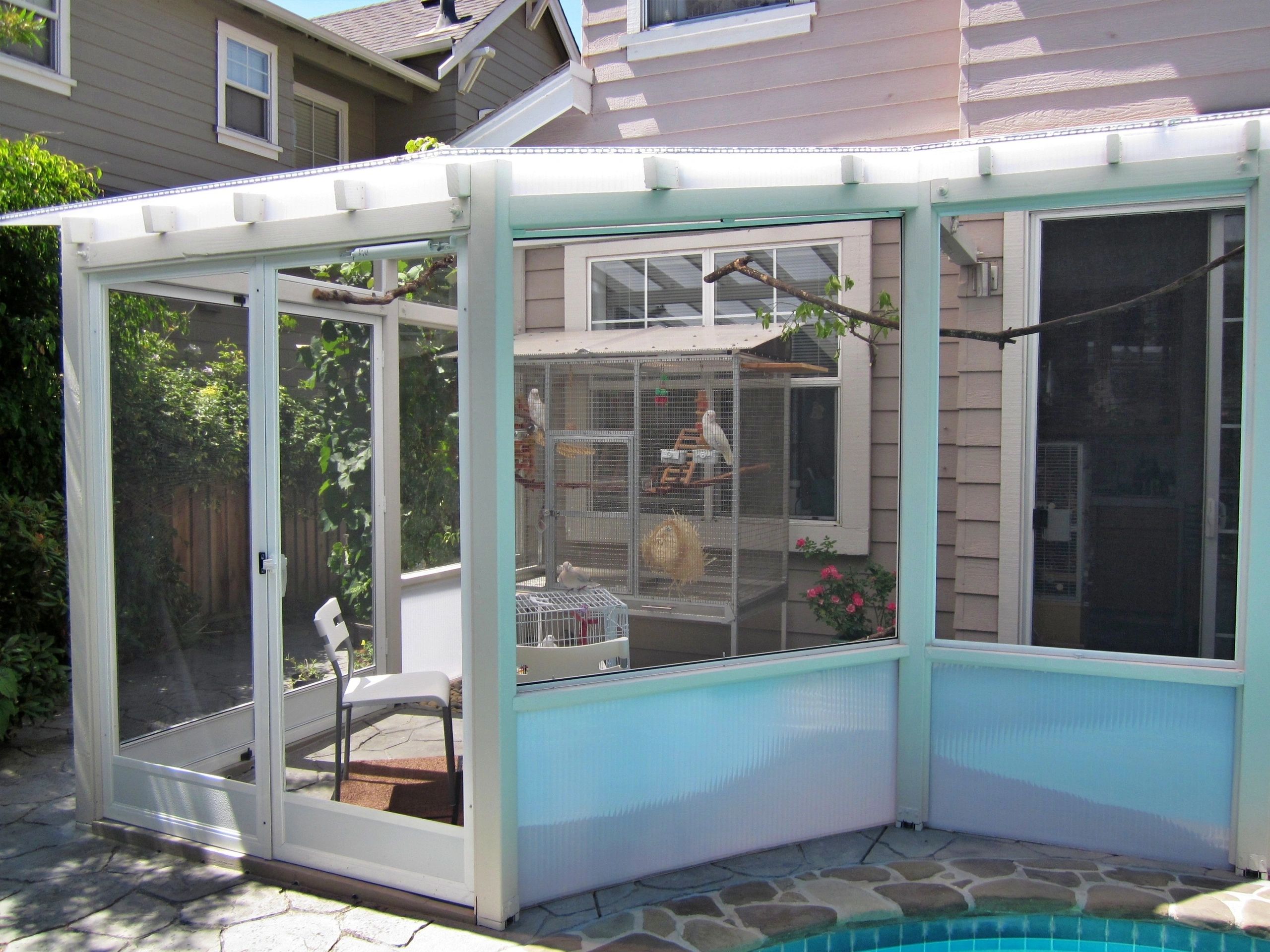Screen porch aviary with Cockatoos. Client design, Birdie Buddy build.