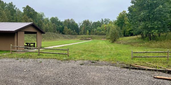 Outdoor gun range with a fence and trees