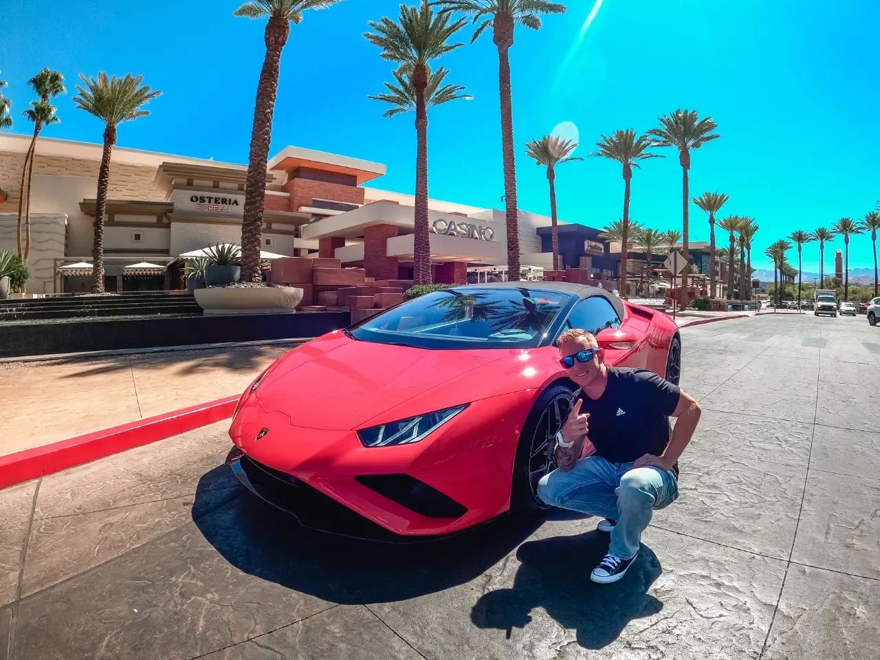 man standing next to a Lamborghini in Las Vegas