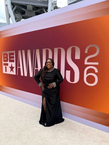 Woman in elegant black dress at the 2023 BET Awards.