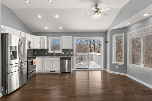 Modern kitchen with stainless steel appliances and hardwood floors.