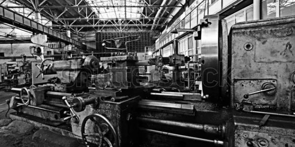 Old industrial lathe machines in a factory.
