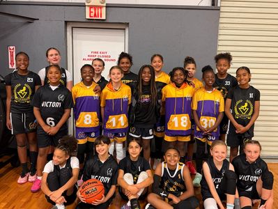 Youth basketball teams in uniforms posing in gym.