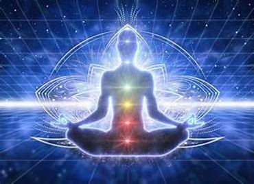 Silhouetted figure meditating with glowing chakras and cosmic background.