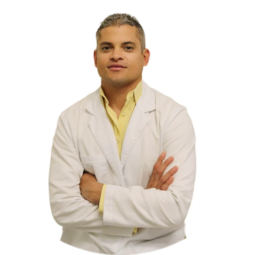 Abel Trimino, Medical Director, smiling in a white medical coat