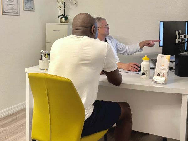 Provider reviewing a form with a patient during an exam