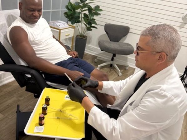 Healthcare provider preparing amino acid and vitamin injections to support muscle recovery and physi