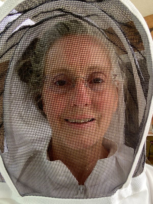 Melanie Yanke in beekeeping suit