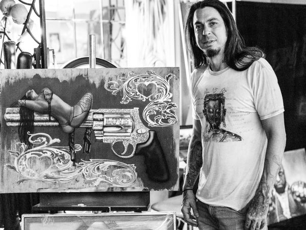 Artist Infamous RudyE presenting his airbrushed filigree revolver and muse
