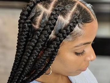 Close-up of large braided hairstyle with neat cornrows.