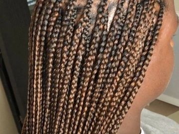 Close-up of brown box braids hairstyle.