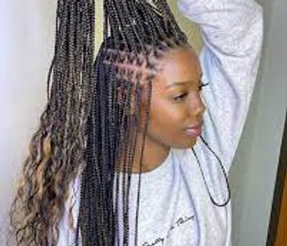 Woman with long braided hair and wavy ends.