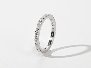 Elegant silver ring with small embedded diamonds.