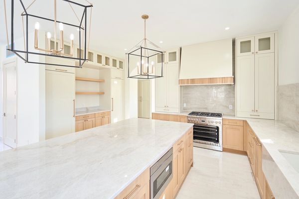 Transitional kitchen with custom white oak wood and Sherwin Williams Neutral Ground cabinets.