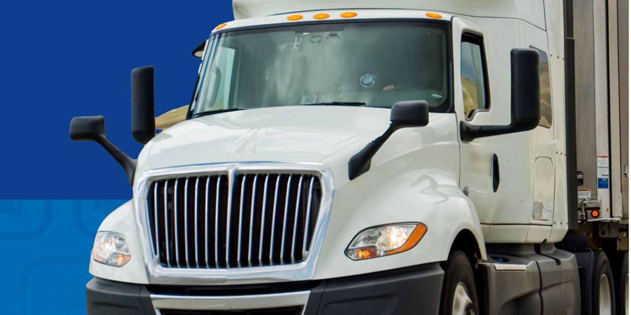 White semi-truck with a blue background.