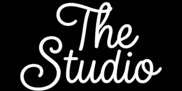 White cursive text reading 'The Studio' on a black background.
