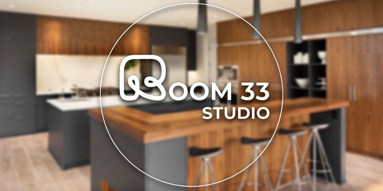 Modern kitchen interior with wooden cabinets and stools.