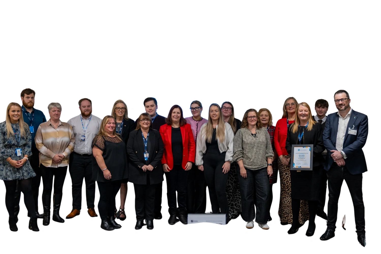 Group photo of smiling professionals, one holding a certificate.