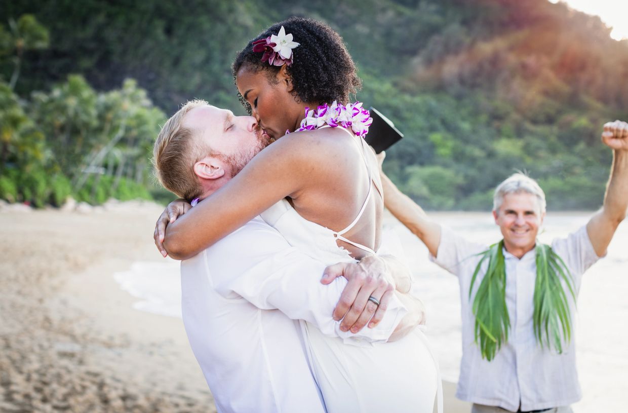 A serene landscape with mountains, a clear blue lake, and lush greenery under a bright sky.