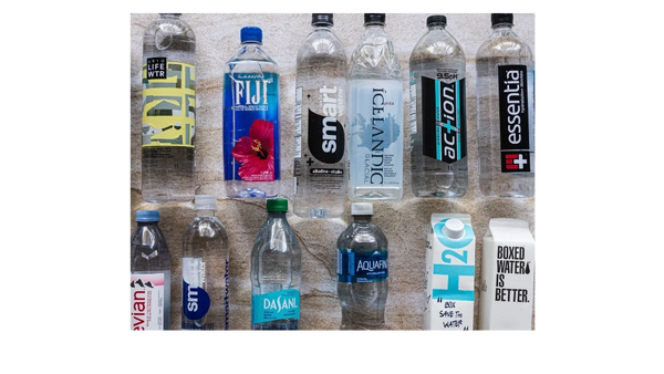 Various popular bottled water brands arranged on a surface.