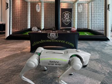 A robotic drone dog displayed in front of a drone soccer net setup.