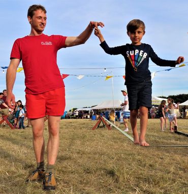 a child holding a slackline teachers hand