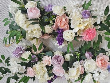 Elegant floral arrangement with pastel roses and greenery.