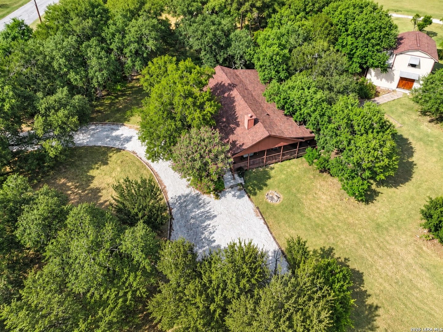 Aerial view of 650 Wild Turkey Run in New Braunfels, Texas, surrounded by mature trees.