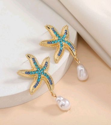 Dangling blue and gold statement earrings for elegant occasions.

