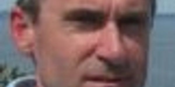 Close-up of a man's face with a blurred background.