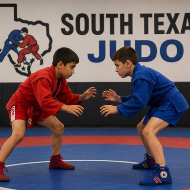 Two boys in red and blue judo uniforms face off on a mat.