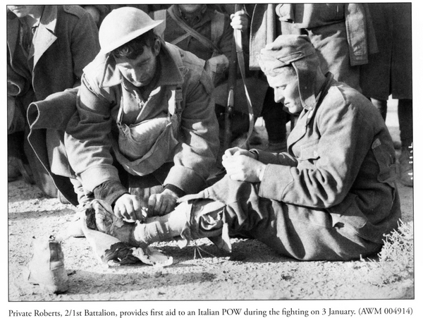 Private Roberts (2/1st Bn) provides first aid to an Italian POW, 1941 Bardia. [The Battle of Bardia]