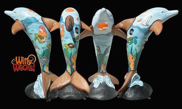 Four dolphin sculptures painted with underwater sea life scenes.
