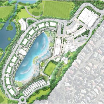 Aerial view of a planned community with a central lake and surrounding buildings.