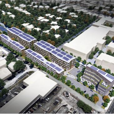 Aerial view of modern buildings with solar panels in a green urban area.