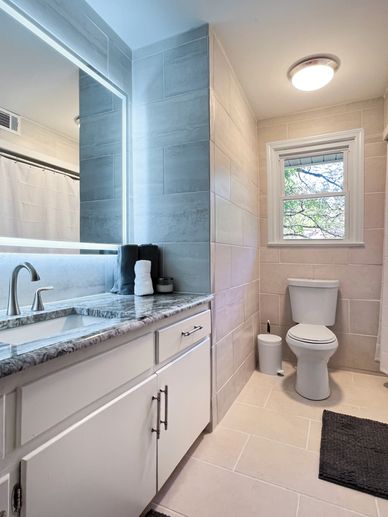 Modern bathroom with a toilet and sink.