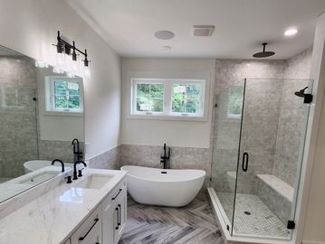 Bathroom remodel, wood plank tile in herringbone pattern, free standing tub, shower with seat and do